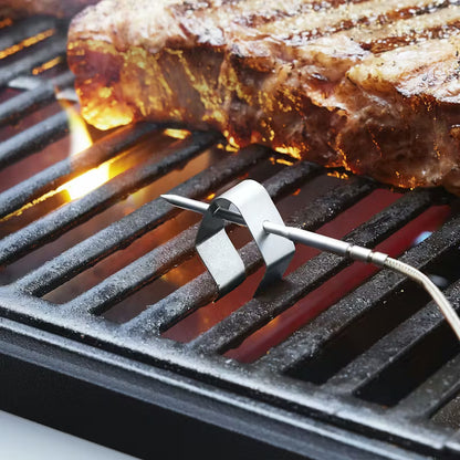 Weber Smart Probe and Grate Sensor attached to a grill while cooking meat